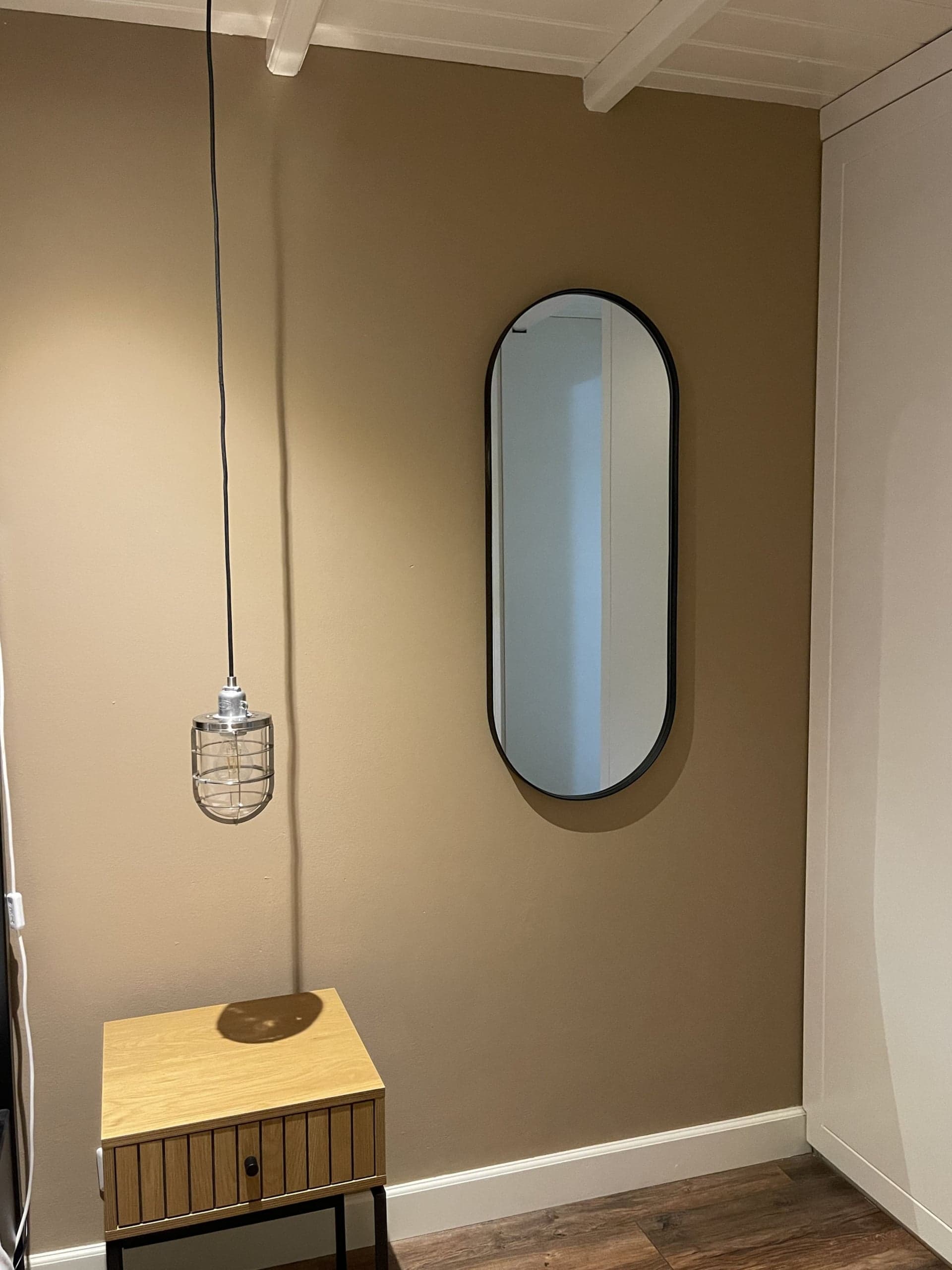 Nachtkastje met hanglamp en spiegel in Zeelicht